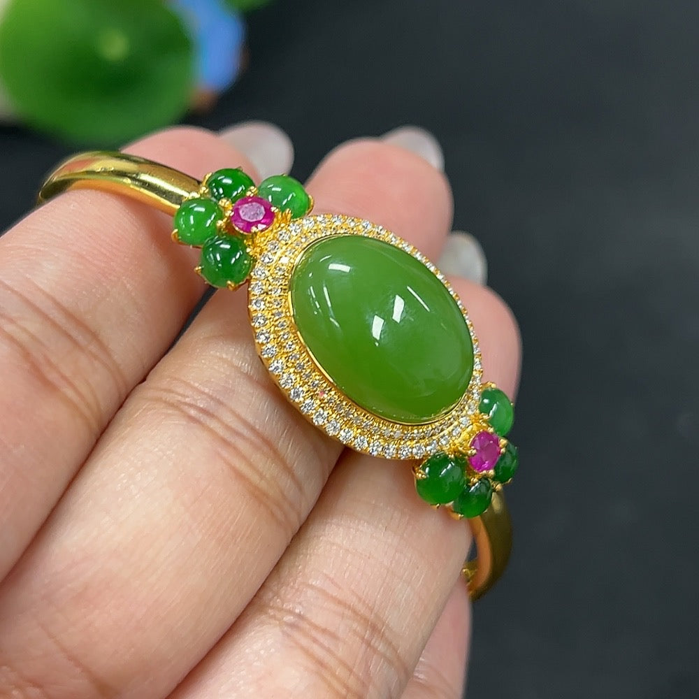 HKHQ Hetian jade bracelet with small jadeite cabochon, 18K gold and diamond accents, showcasing intricate craftsmanship and elegant design.