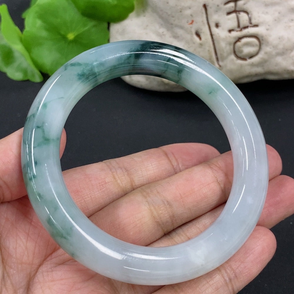 HKHQ jadeite round bangle, size 54.9, with mineral components, weighing approximately 65.2g, showcasing smooth polished surface.