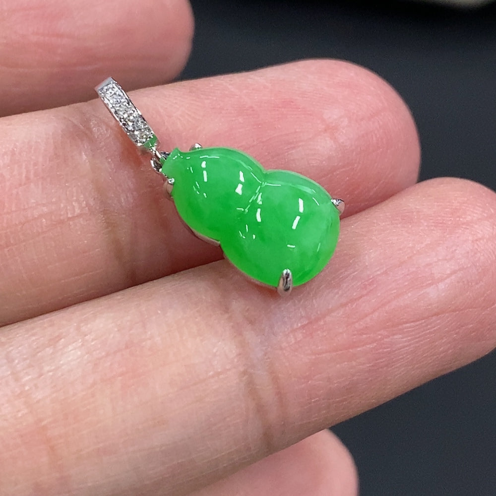 Jadeite gourd pendant with 18K gold and diamond accents, featuring intricate inlay work and a polished finish.