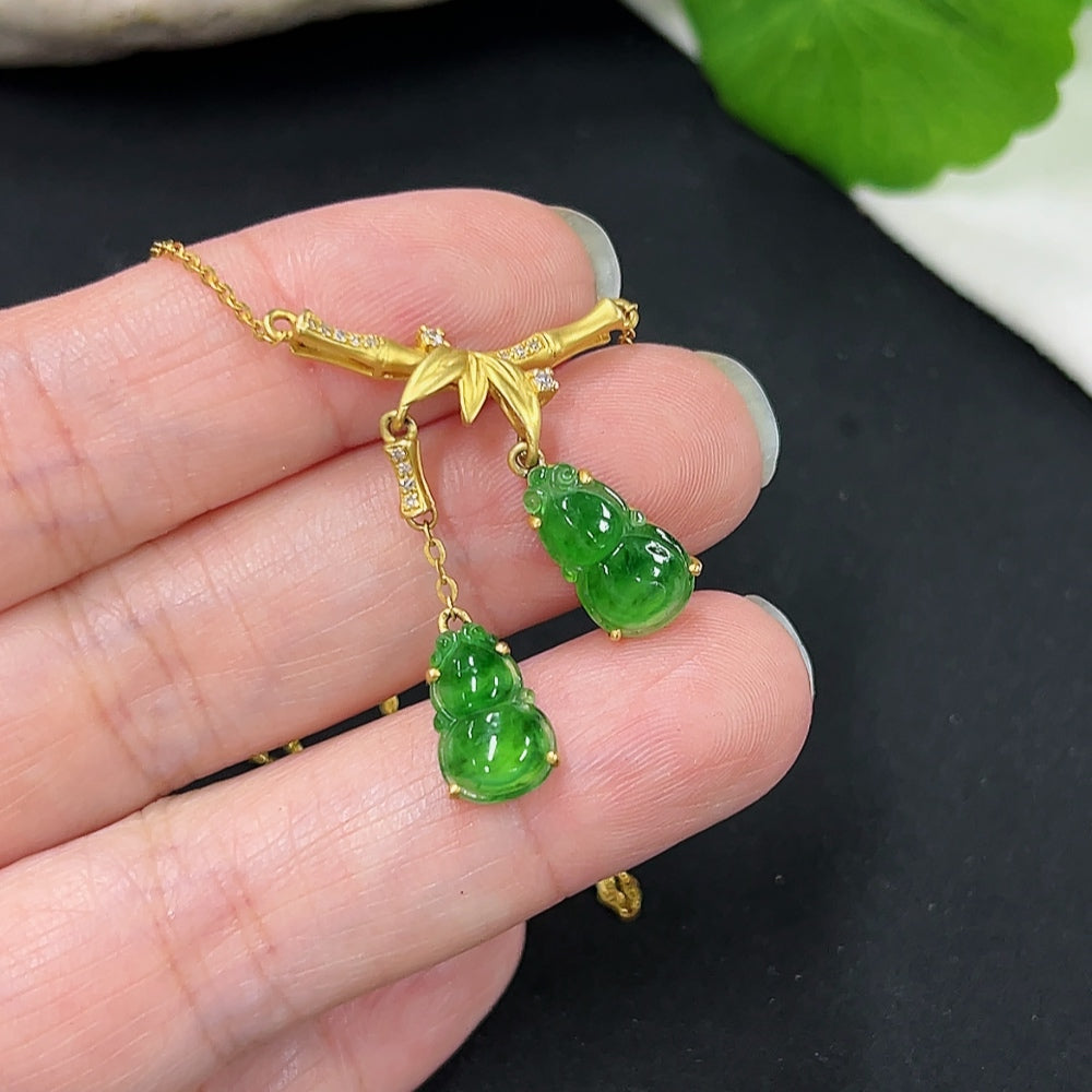 Jadeite inlaid gourd pendant with 18k gold and diamond accents, shown with chain, weighing approximately 4.29g, by HKHQ.