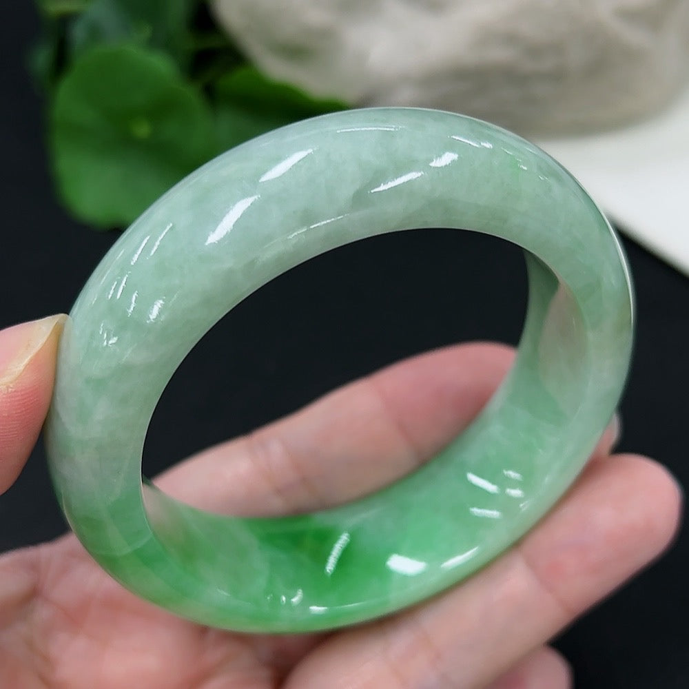 Jadeite round bangle in size 53.6 with approximately 82g weight, showcasing smooth, polished green jade from HKHQ.
