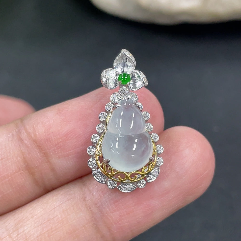 Jadeite gourd pendant with 18K gold and diamond accents, showcasing intricate design on a necklace.
