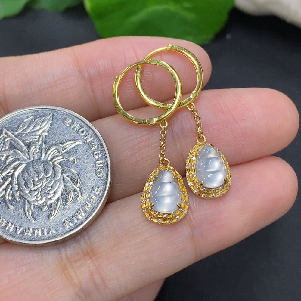 Jadeite auspicious bean earrings set in 18K gold with diamond accents, featuring smooth jade beads and gold hooks.