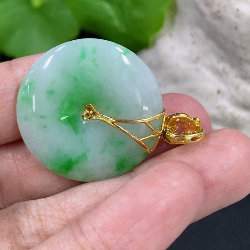 Jadeite peace knot pendant with 18K gold clasp and diamond accents, showcasing intricate design and polished jade surface.