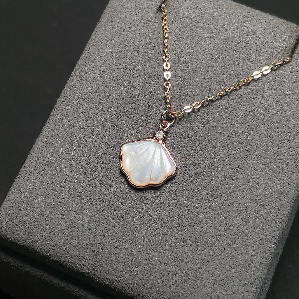 Shell pendant with diamond accents, 18K gold chain (pendant not gold), total weight approximately 2.72g including chain