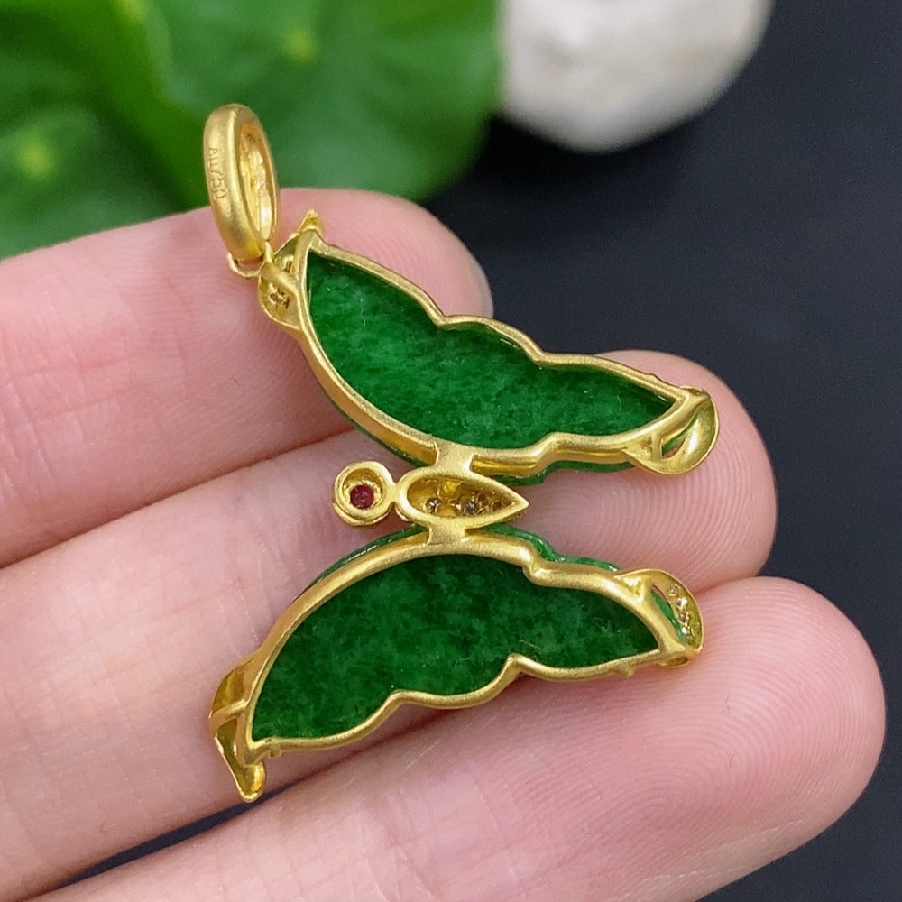 Jadeite pendant with 18k gold mount and diamond accents, featuring mineral inclusions, on a necklace chain.
