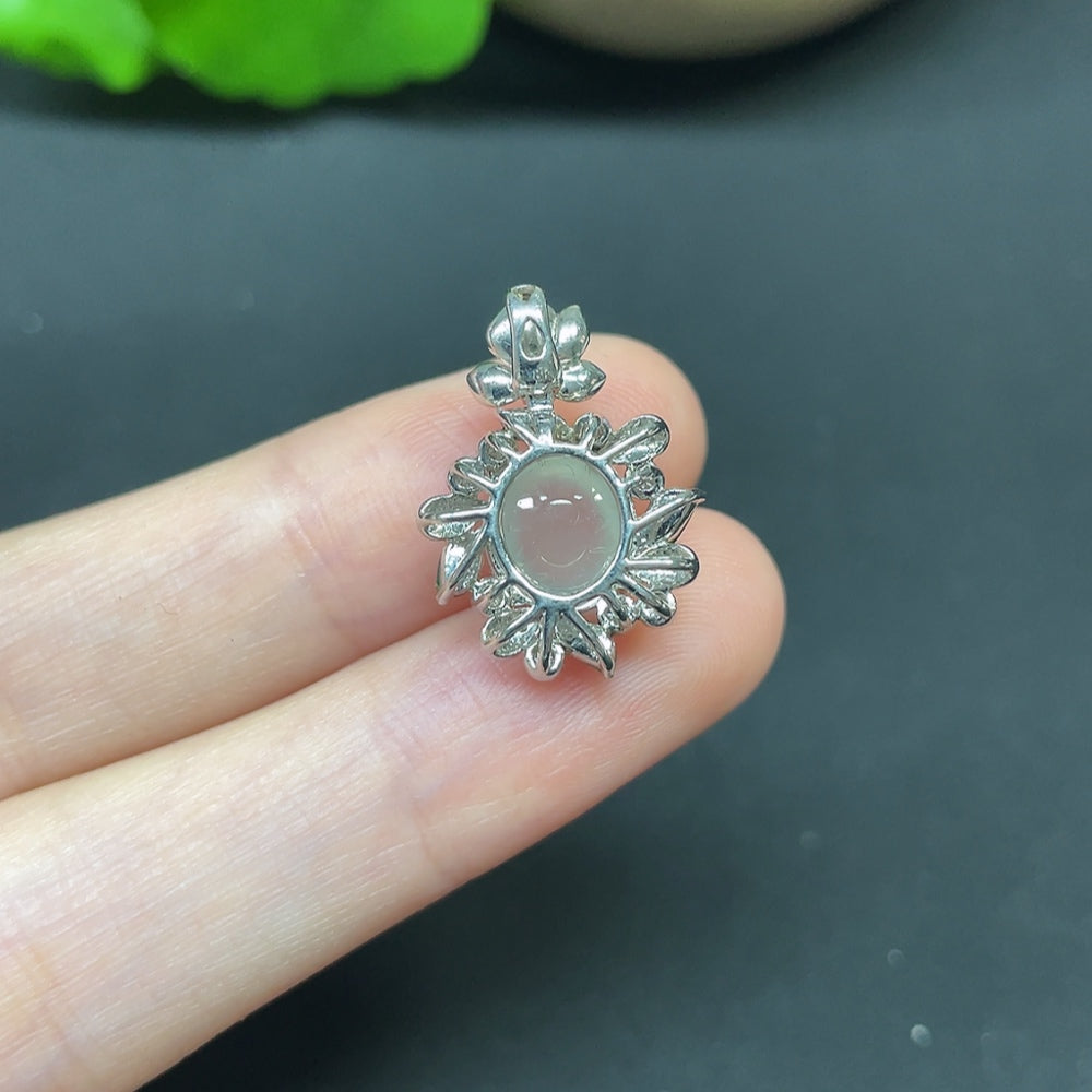 Jadeite cabochon pendant in 18K gold with diamond accents, elegant necklace featuring a smooth, polished green jade stone.
