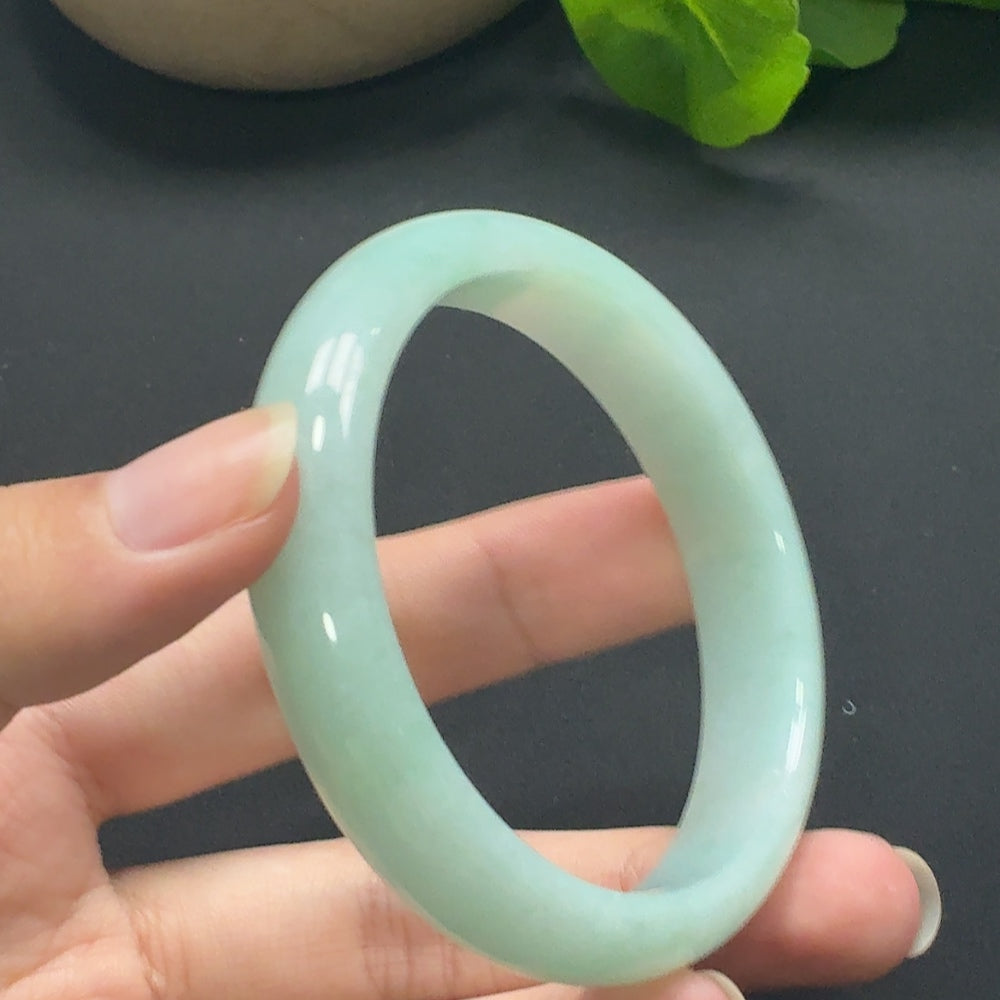 Round jadeite bangle with size 55.8 and approximately 45.69g weight, showcasing smooth, polished jade surface.