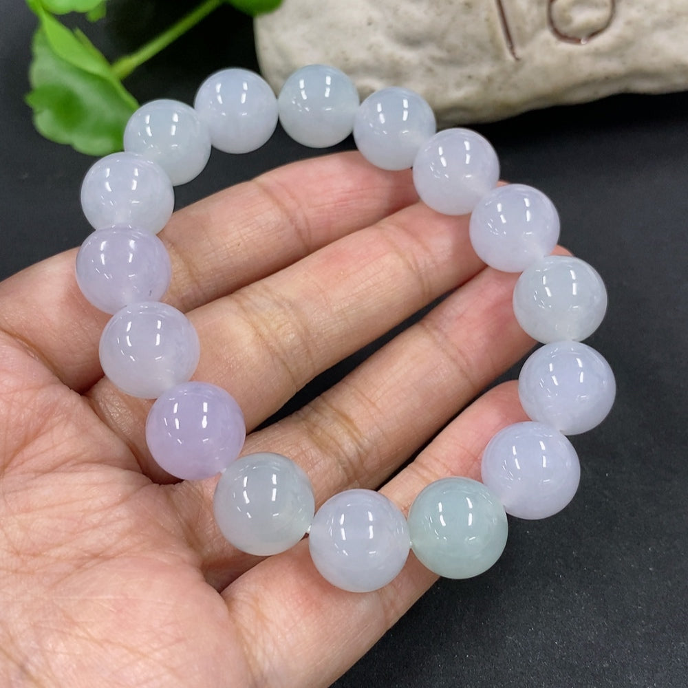 HKHQ jadeite bracelet with 12mm beads, weighs approximately 49.7g, featuring smooth, polished jadeite stones on a flexible bracelet.