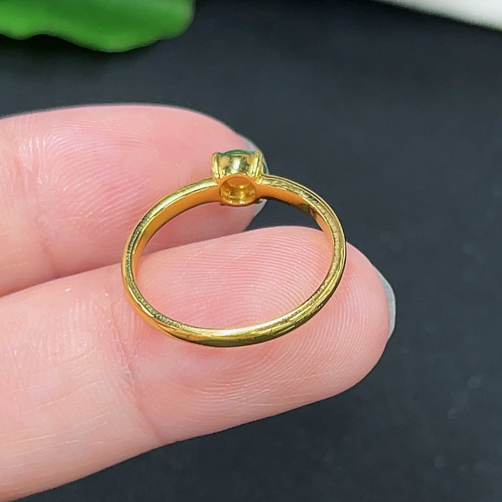 Gold jewelry ring with jadeite inlay, crafted in 18K gold, featuring elegant and intricate design details.