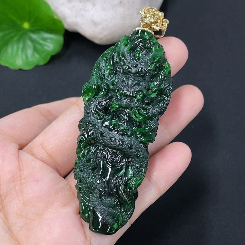 Jadeite pendant featuring a dragon plaque with 18K gold accents, crafted from green jade, displayed against a neutral background.