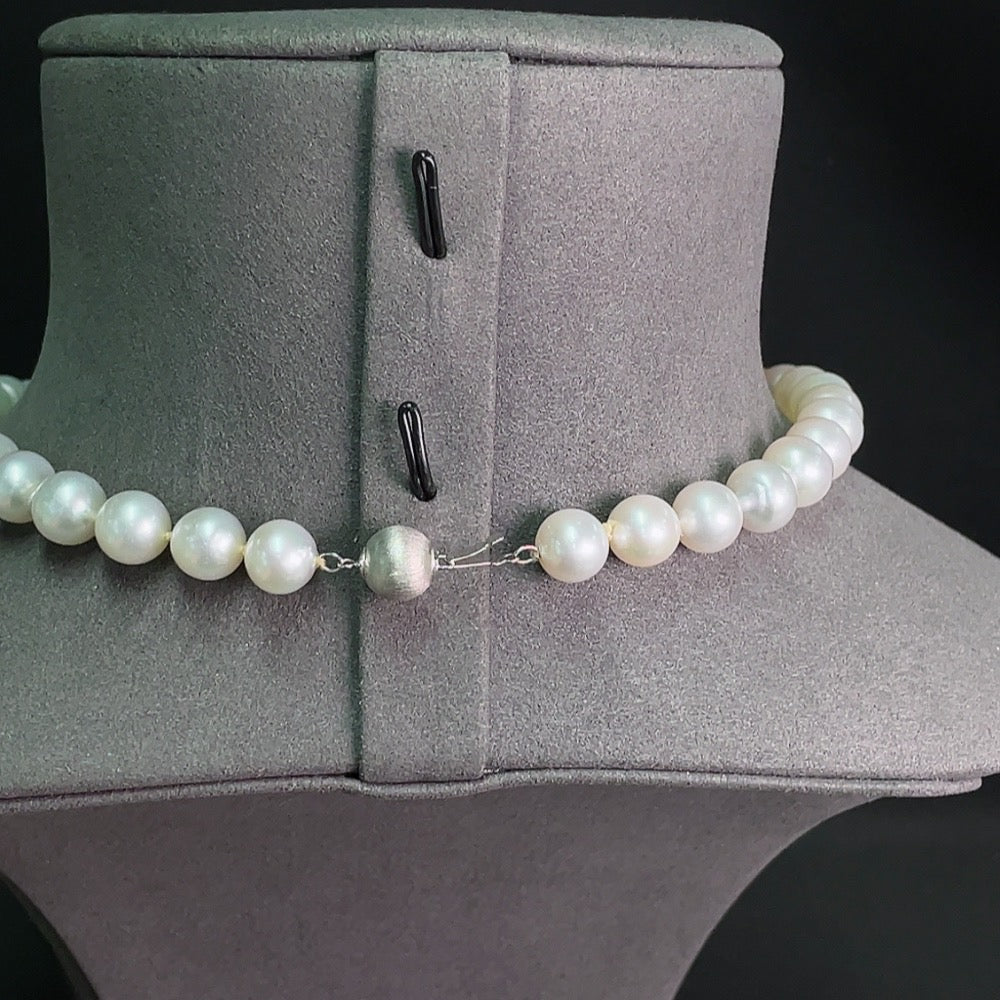 Saltwater pearl strand necklace with 14K gold clasp, featuring lustrous pearls on a classic design.