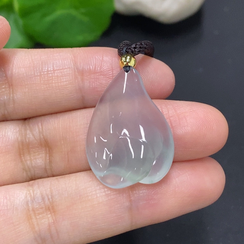 Jadeite freeform pendant with natural green jade, weighing approximately 7.2g, featuring polished smooth surface and attached rope.