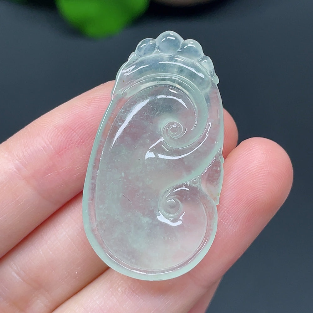 Jadeite Ruyi pendant with polished surface, weighing approximately 7.36g, showcasing elegant green jade craftsmanship.