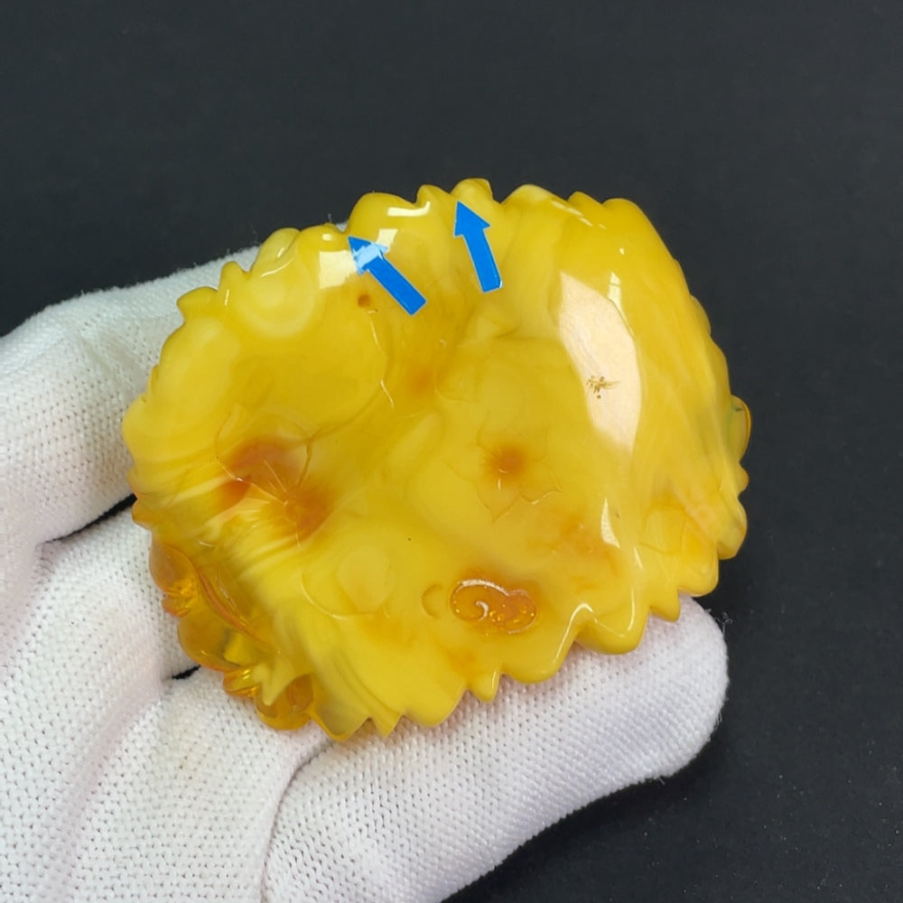 Amber beeswax pendant with visible repairs, weighing approximately 36.25g, crafted by HKHQ in natural amber color.