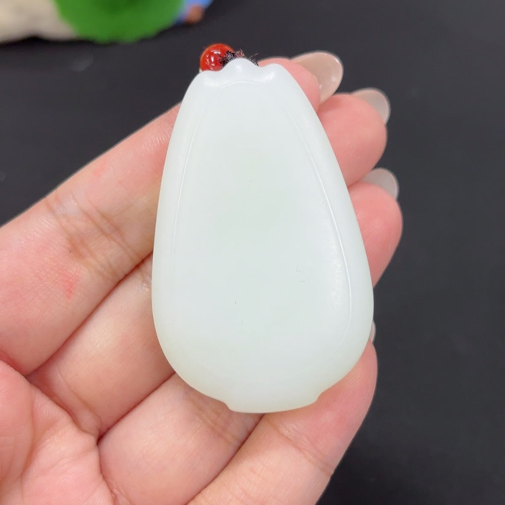 Plain Hetian jade pendant with cord, weighing approximately 48.1g, featuring smooth, polished jade gemstone in natural green tones.