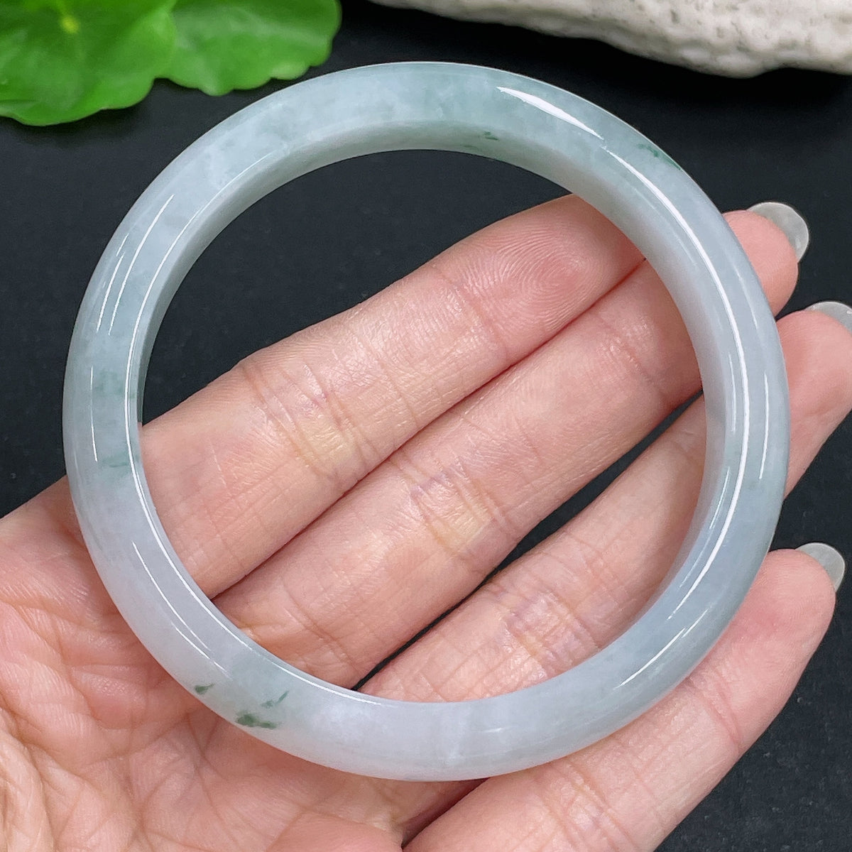 HKHQ jadeite round bangle in size 59.3 with a weight of 51.46g, showcasing smooth, polished green jade jewelry.
