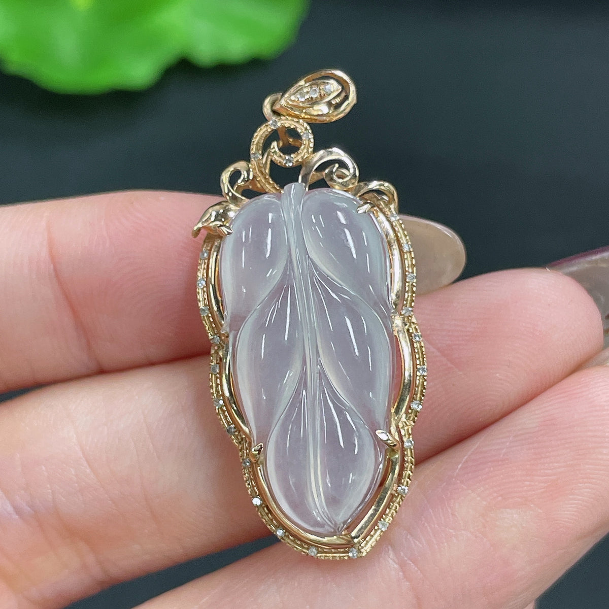 Jadeite pendant leaf with 18k gold and diamond inlay, crafted by HKHQ, showcasing a detailed jade leaf design with sparkling accents.