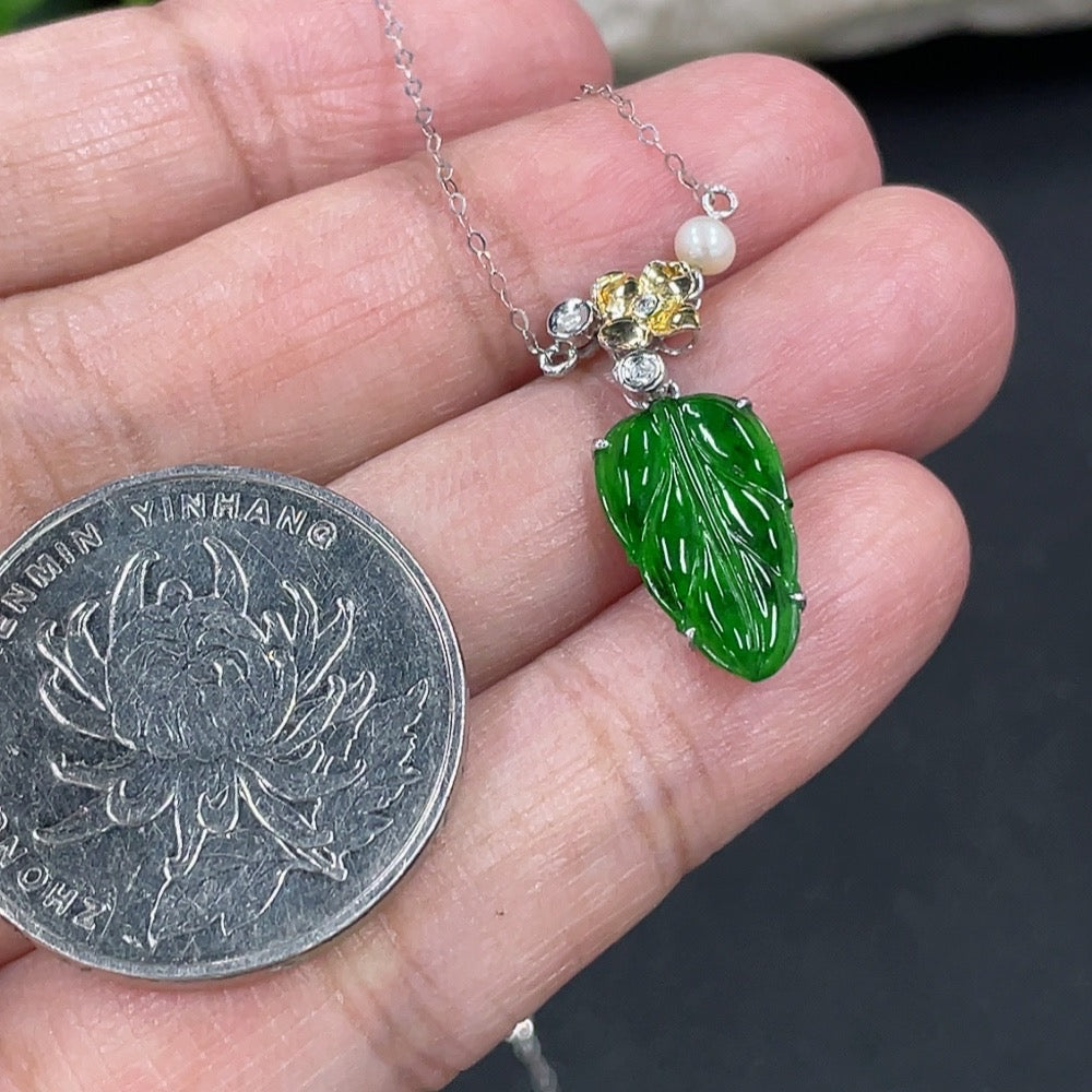 Jadeite leaf pendant with 18K gold and diamond accents, featuring a delicate chain, crafted by HKHQ.
