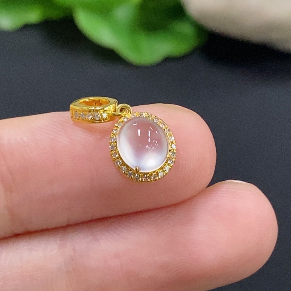 Jadeite cabochon pendant with 18K gold and diamond accents, showcasing a delicate necklace design.