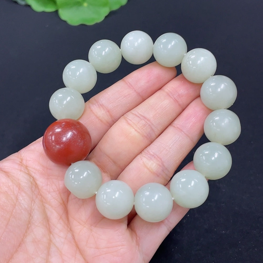 HKHQ Jade bracelet with 13.6mm beads, weighing 64.9g, featuring smooth jade beads, natural stone appearance, no specific skin tone indication.