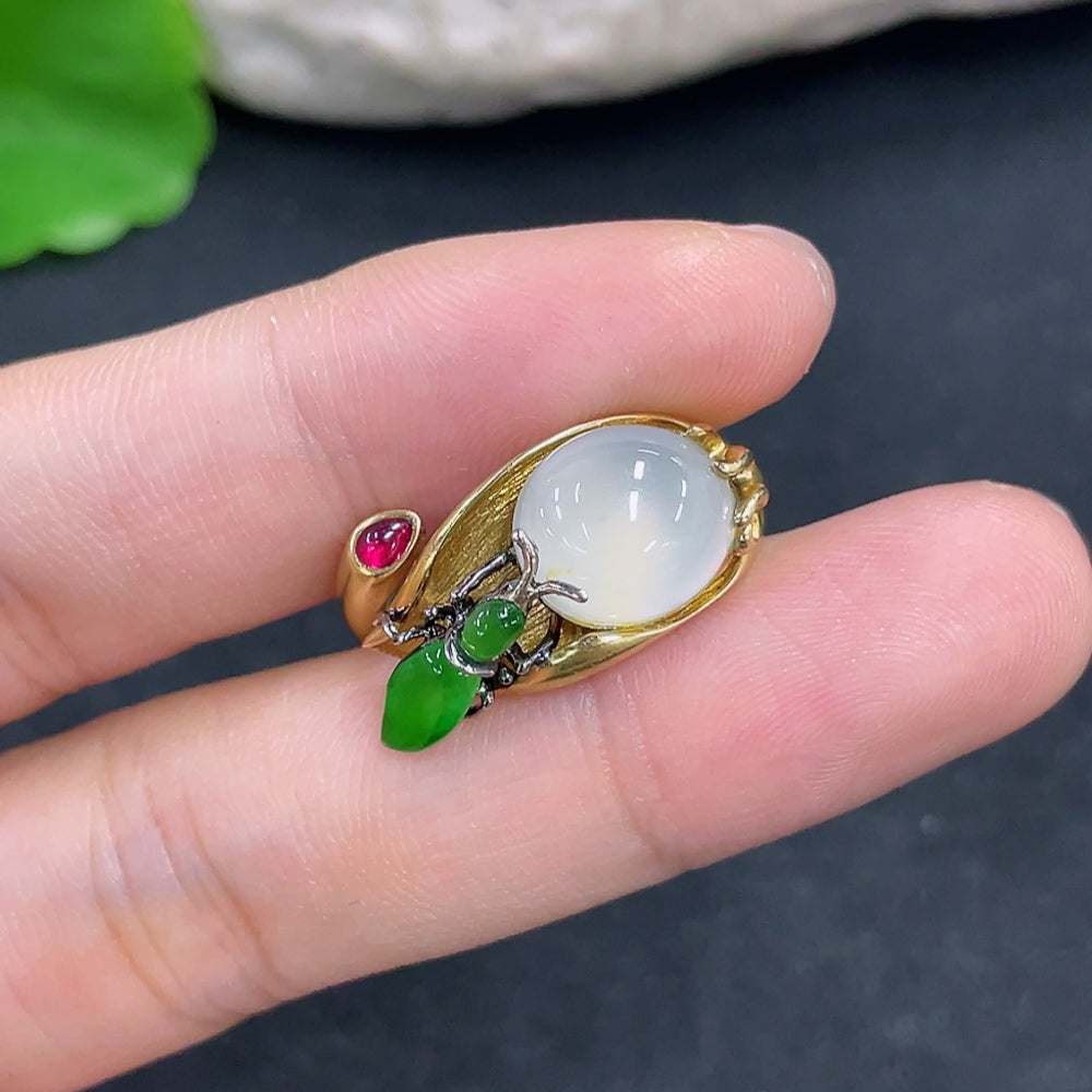 Jadeite ring with 18k gold band, size 14, weighing approximately 9.5g, featuring a polished green jade gemstone.