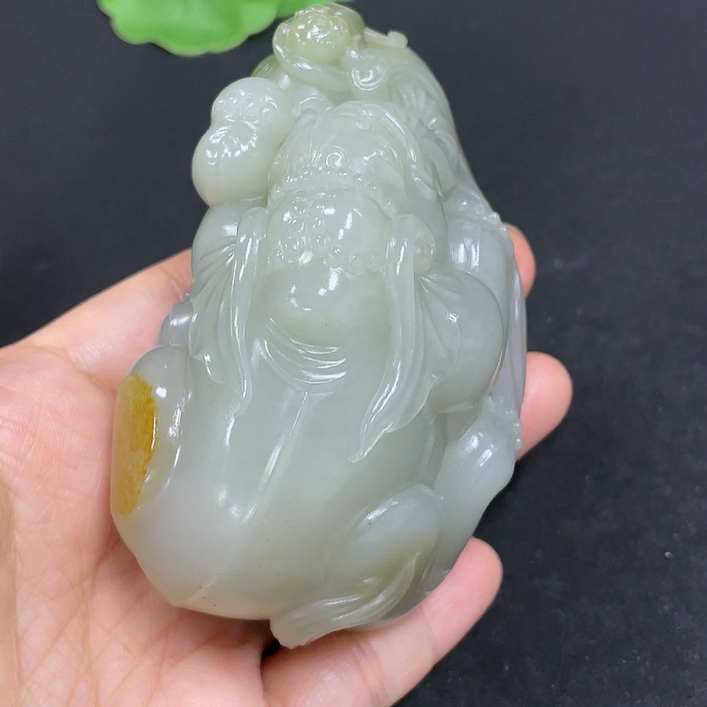 Hetian Jade seed hand piece by HKHQ featuring smooth, polished jade with intricate carvings, showcasing traditional craftsmanship.