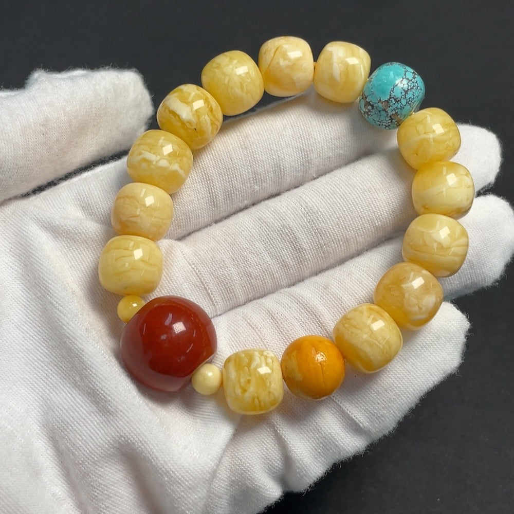 Amber beeswax bracelet featuring southern red gemstone beads, organic matter details, and natural gemstone appearance.