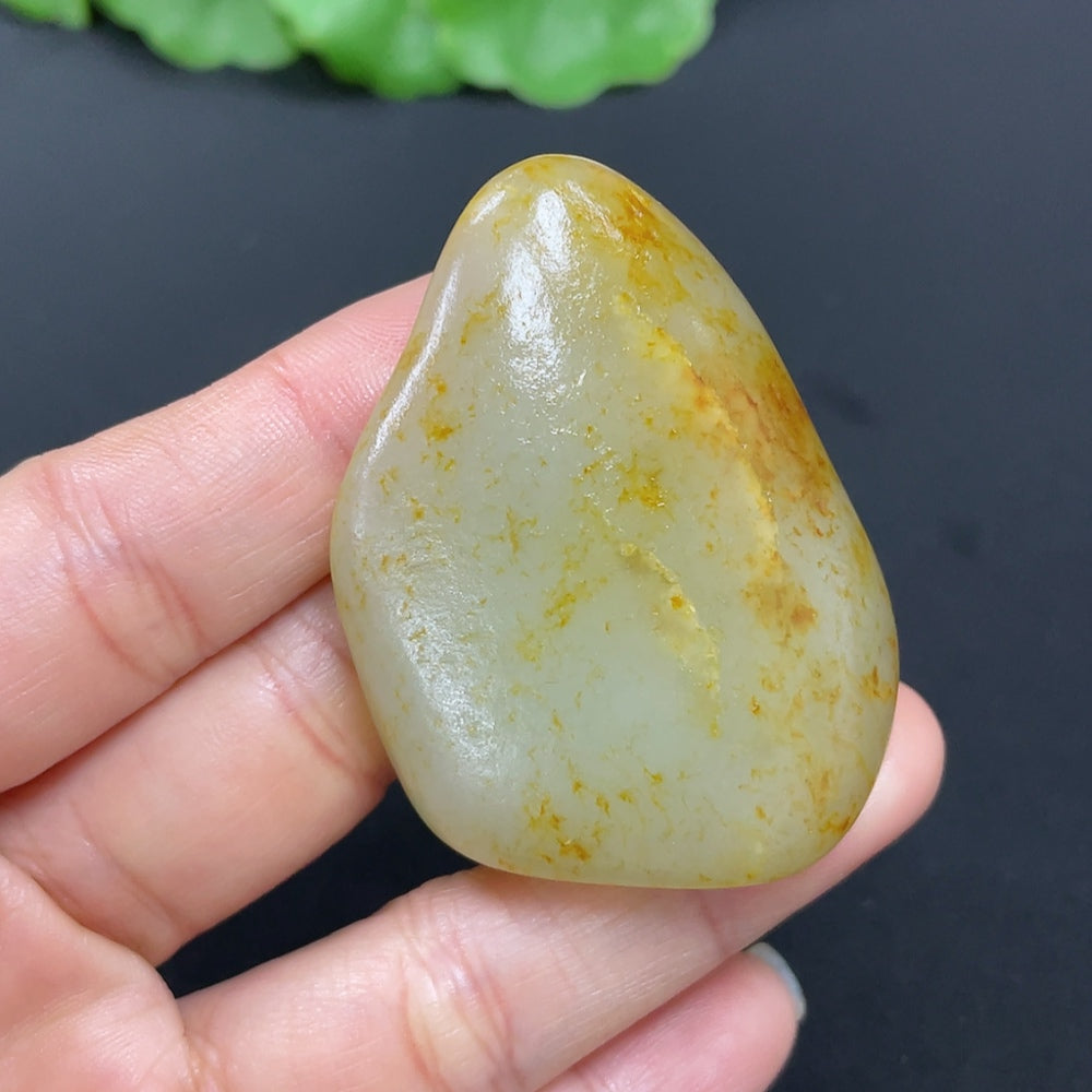 HKHQ Hetian Jade pendant, approximately 41.6g, showcasing smooth green jade with natural variations and polished surface.