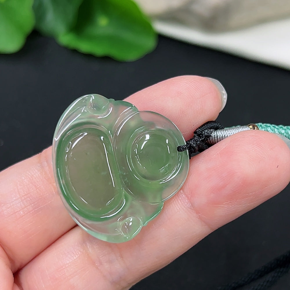 Jadeite Buddha pendant with rope, weighing approximately 9.2g, featuring a detailed Buddha design on smooth jade stone.
