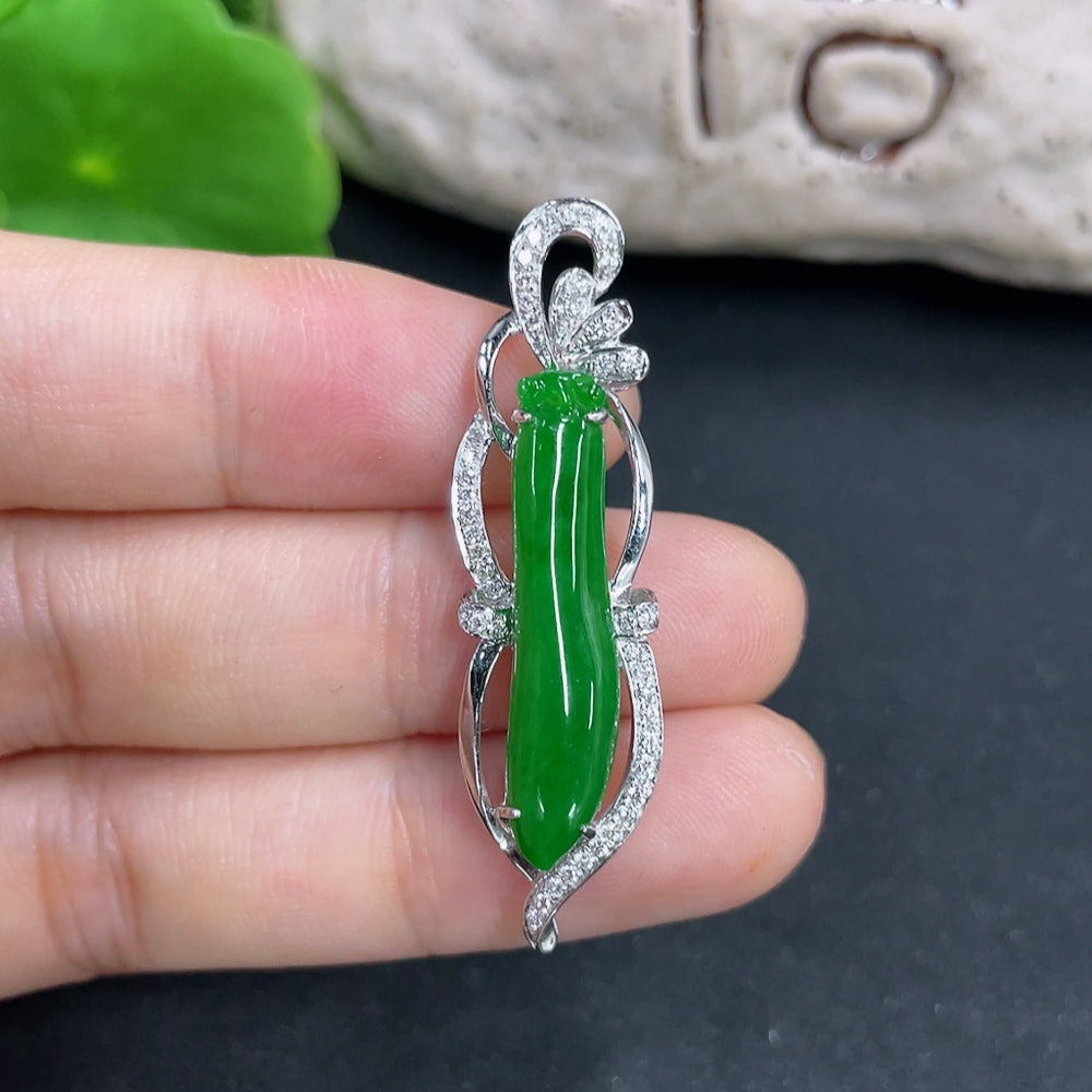 Jadeite pendant necklace set with 18K gold and diamonds, featuring a polished green jadeite gemstone on a delicate gold chain