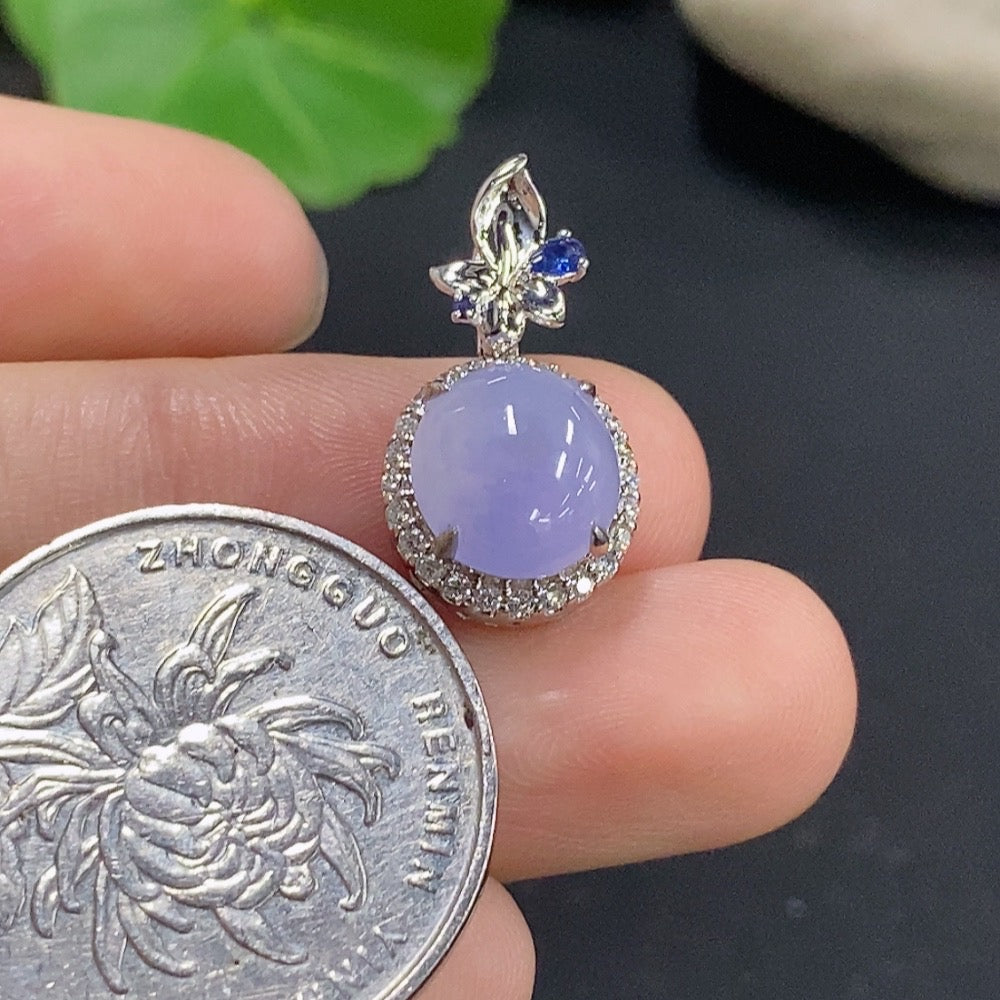Jadeite cabochon pendant with 18k gold and diamond accents, showcasing a polished green jade stone and intricate gold details.