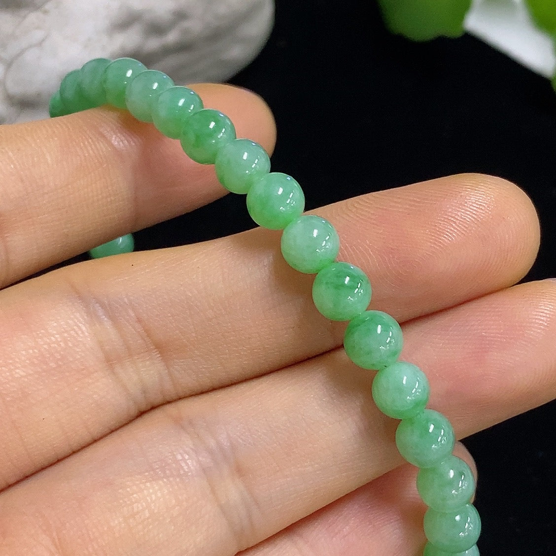 Jadeite bracelet with 5.6mm jade beads from HKHQ, non-gold, totaling approximately 11.96 grams, displayed in close-up.
