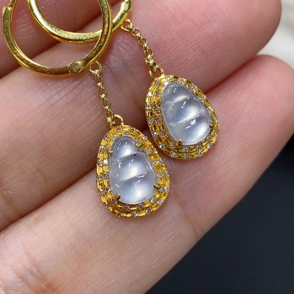 Jadeite auspicious bean earrings set in 18K gold with diamond accents, featuring smooth green jade beans and gold hooks.