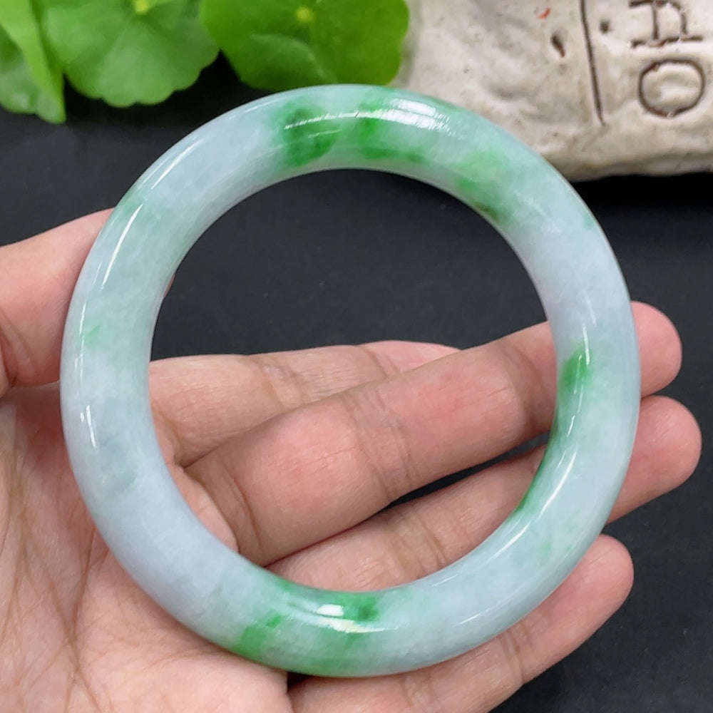 Beautiful jadeite round bangle from HKHQ showcasing smooth, polished jade with a rounded shape and elegant appearance.