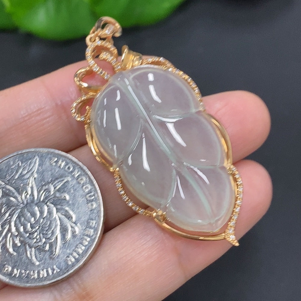 Jadeite leaf pendant with diamond accents in 18k gold, weighing approximately 7.2g, featuring detailed jade and gold craftsmanship.
