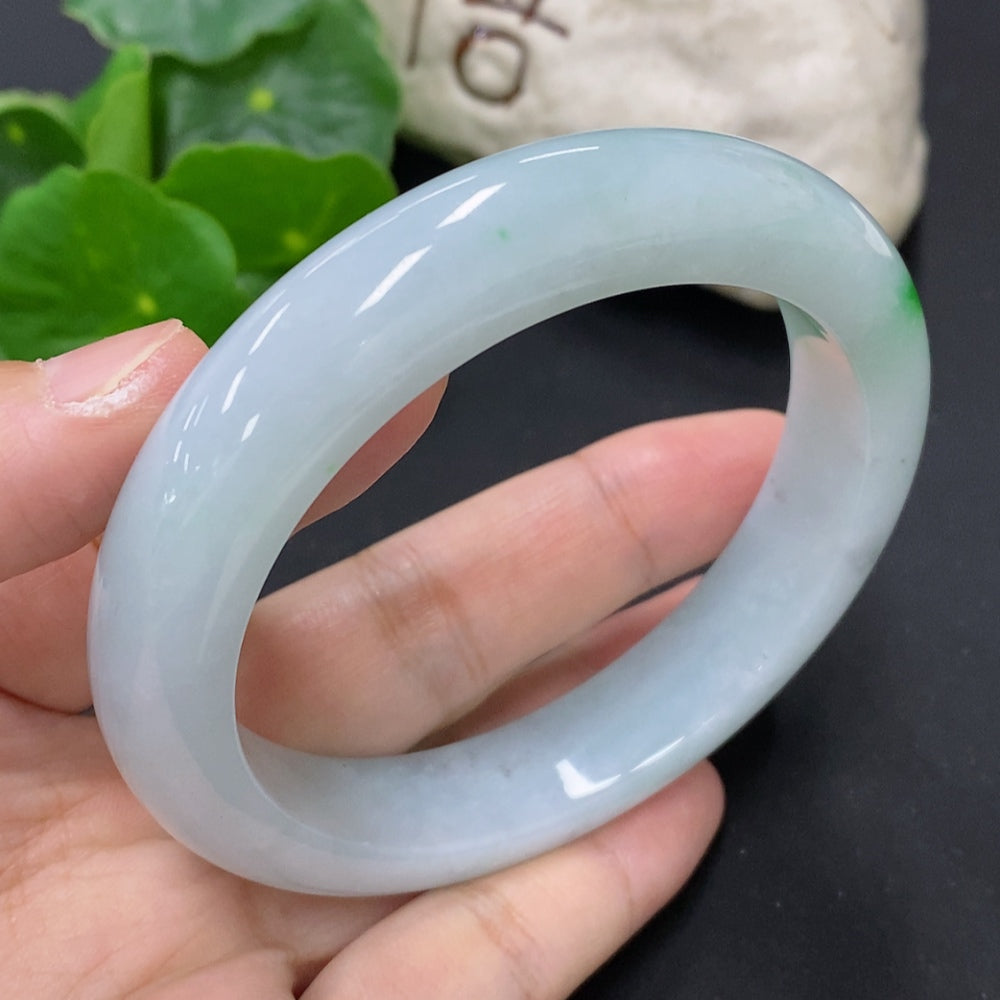 Jadeite round bangle from HKHQ, size 59.2, weighing approximately 69.6g, featuring smooth, polished jade surface.
