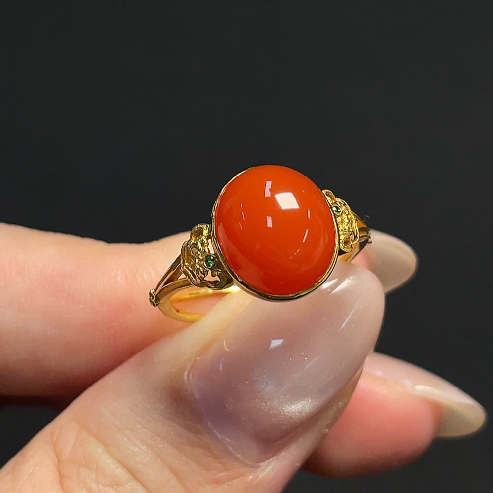 South Red Agate ring by HKHQ featuring 18k gold band with non-natural accent stones, size 15, weighing approximately 3.11g.