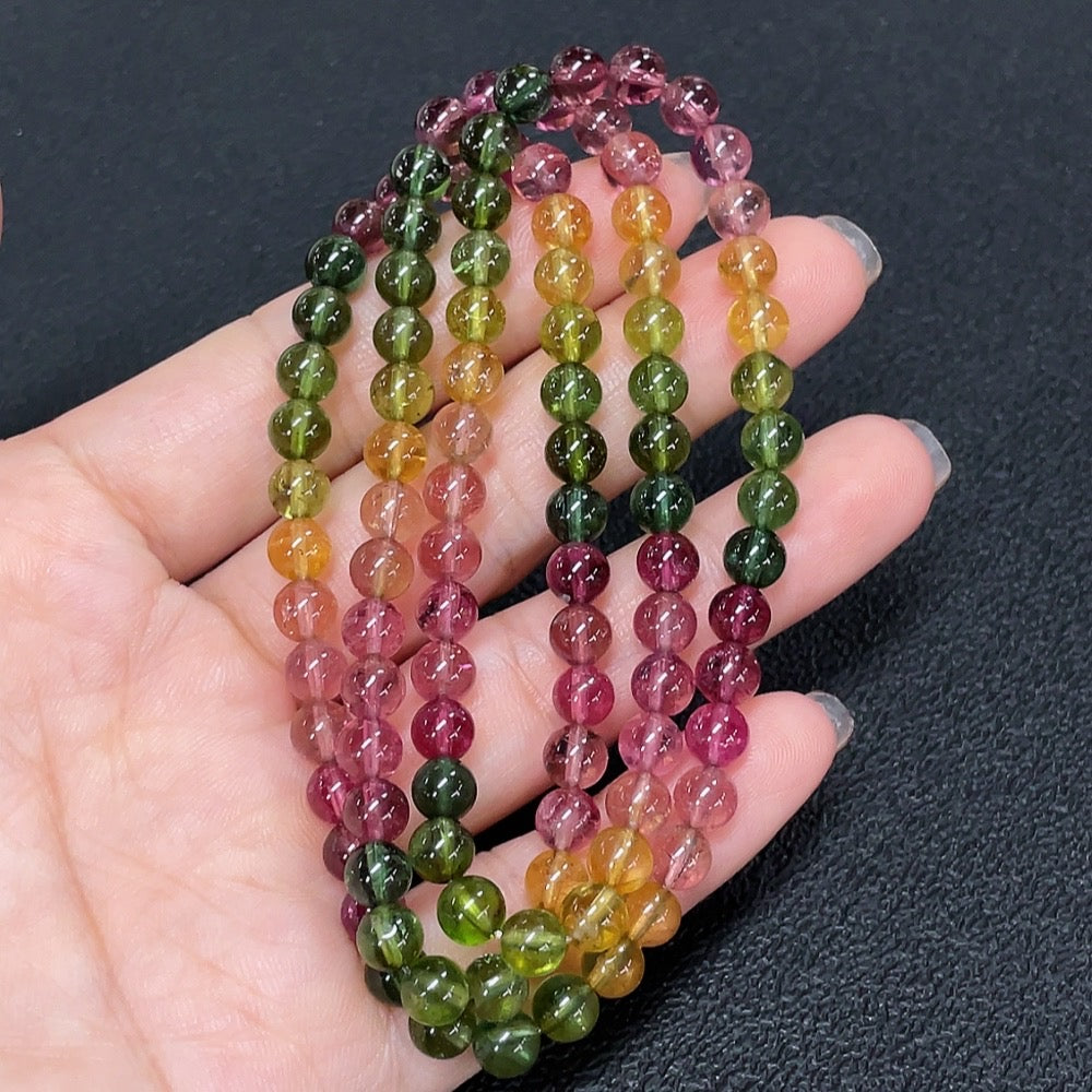 HKHQ tourmaline bead strand necklace featuring vibrant, multi-colored round beads on a delicate string.