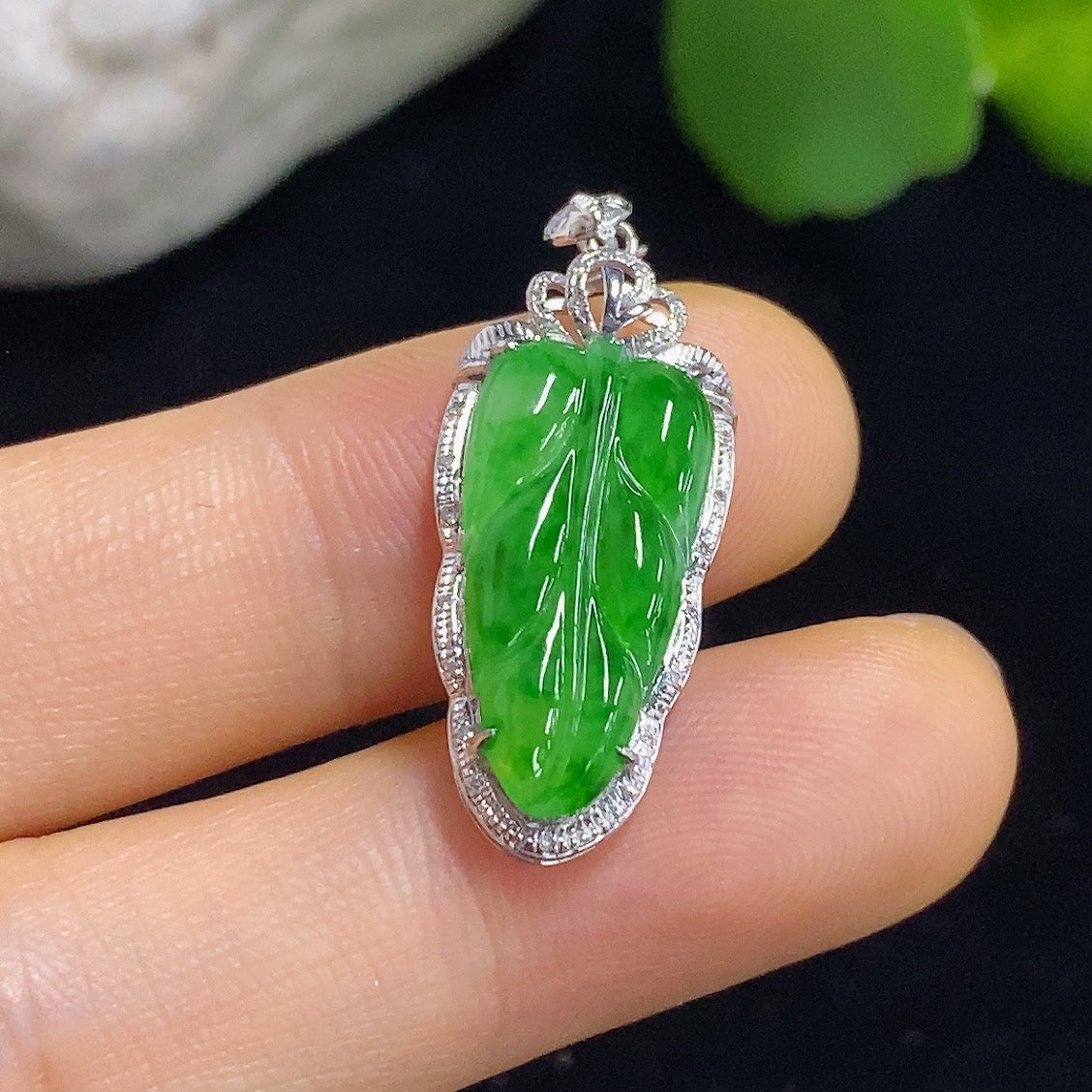 Jadeite leaf inlaid pendant with 18k gold and diamond accents, featuring detailed leaf design and a delicate chain.