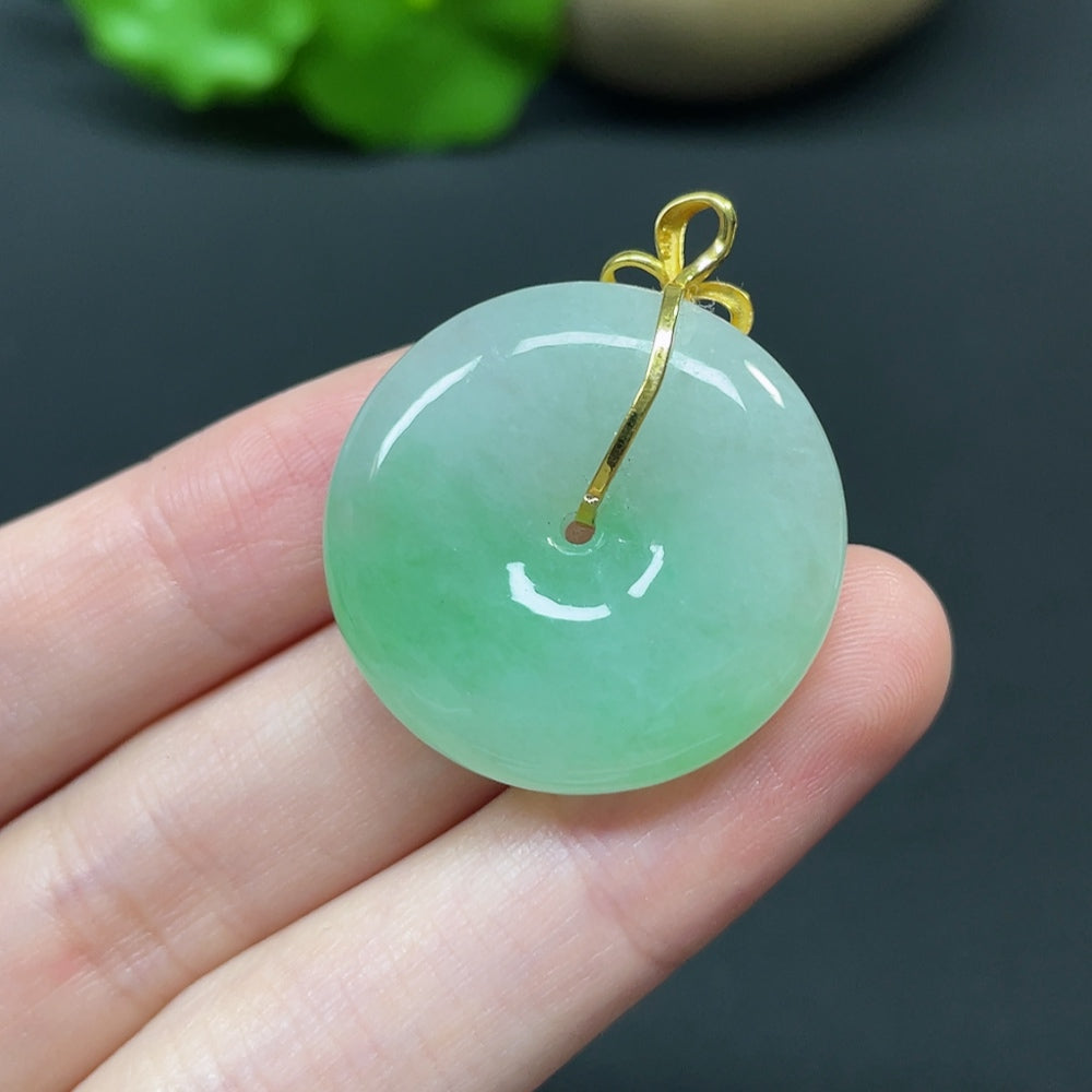 Jadeite Peace Knot pendant with 18k gold, diamond side stones, intricate inlaid design, weighing approximately 10.92 grams.