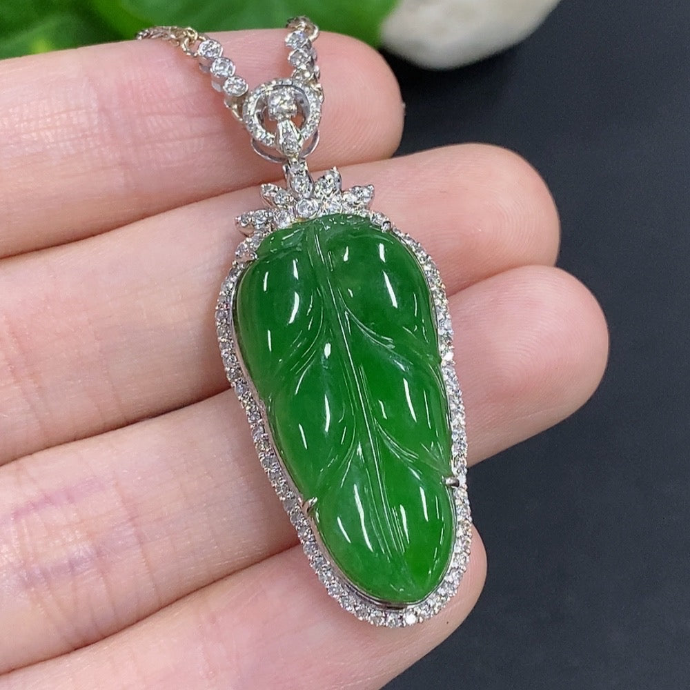 Jadeite leaf pendant with 18K gold and diamond accents, featuring a delicate chain, weighing approximately 12g.