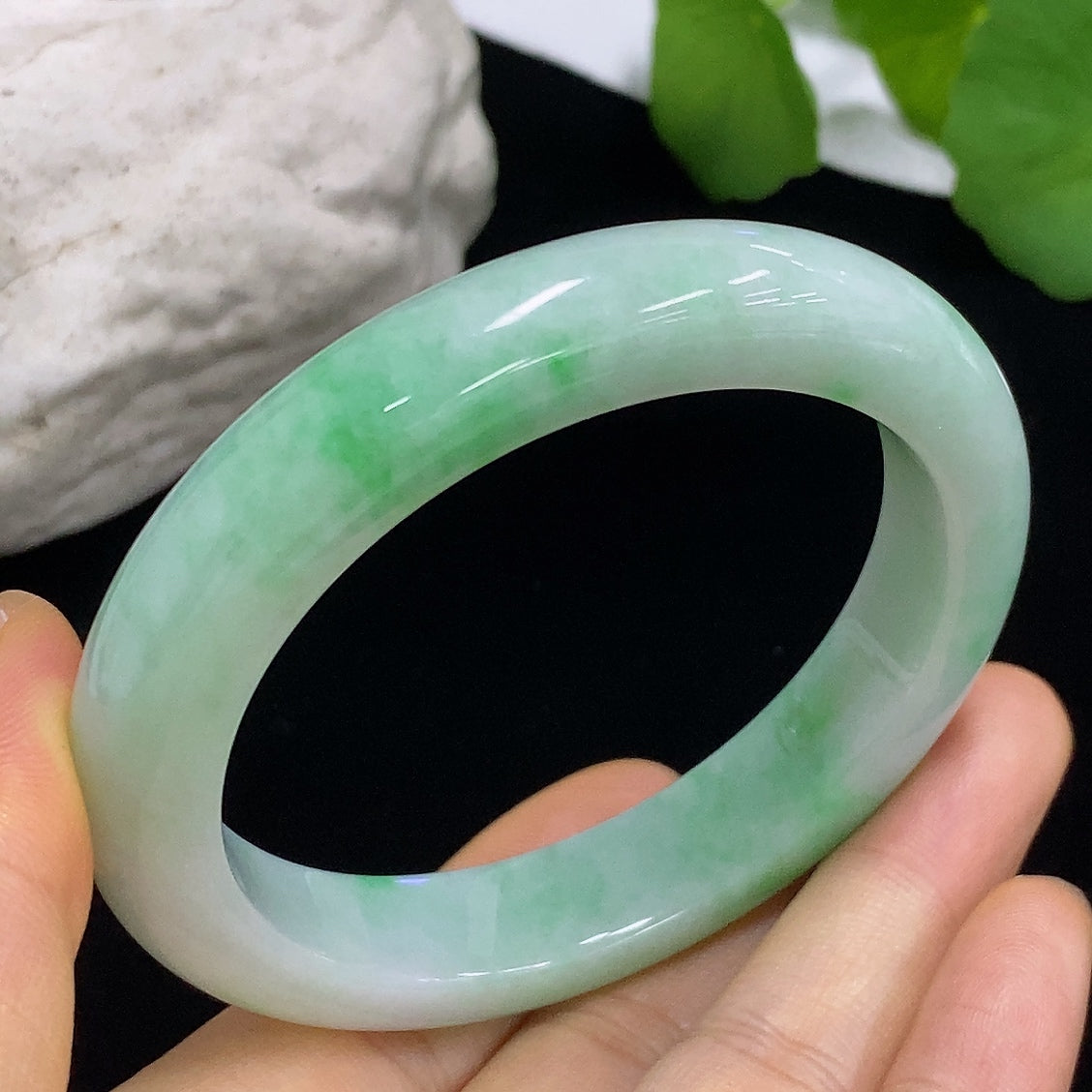 HKHQ jadeite round bangle with a 55.4mm size and 57.1g weight, smooth polished surface, showcasing vibrant green jade color.