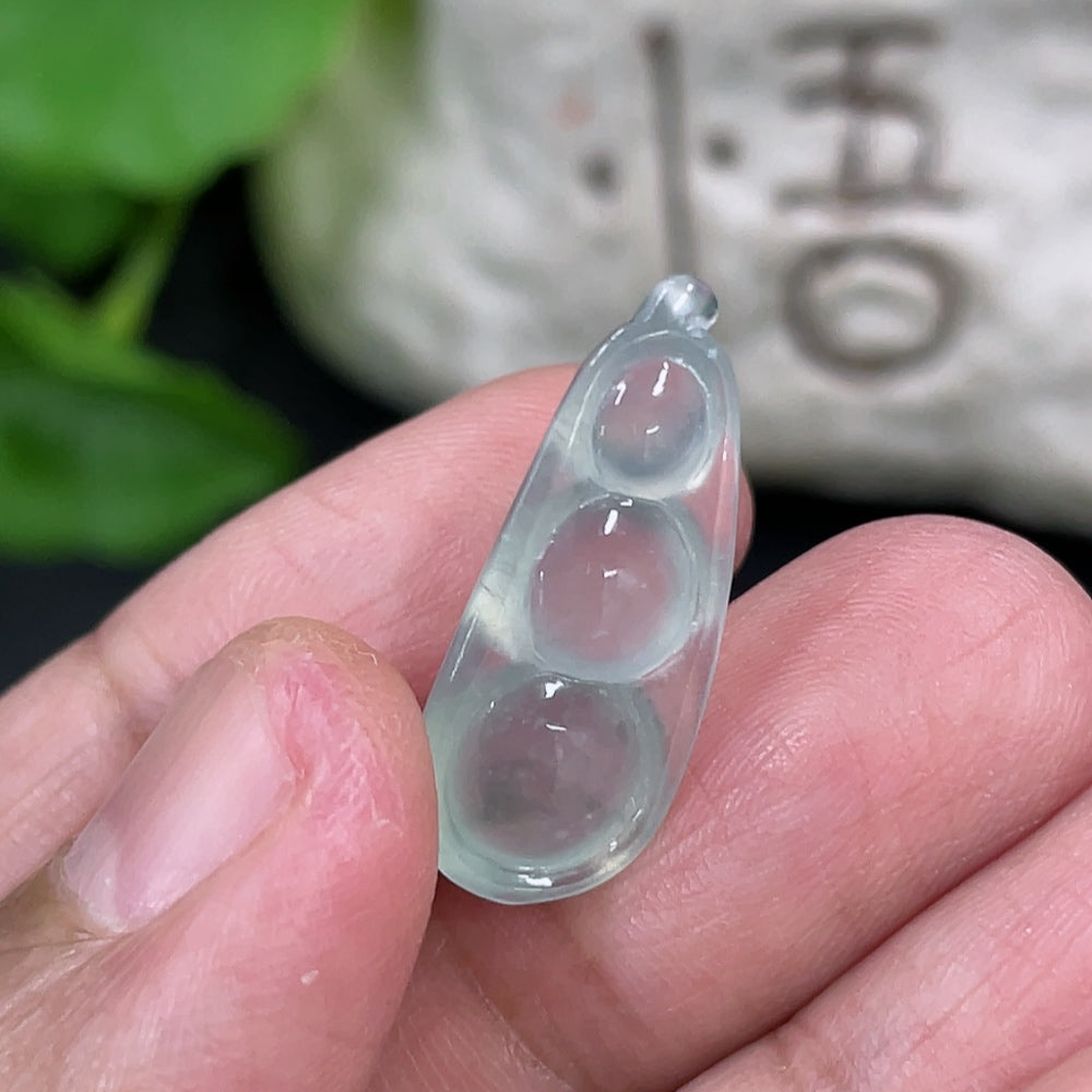Jadeite auspicious bean inlay piece from HKHQ, weighing approximately 1.88g, showcasing detailed green jade craftsmanship.