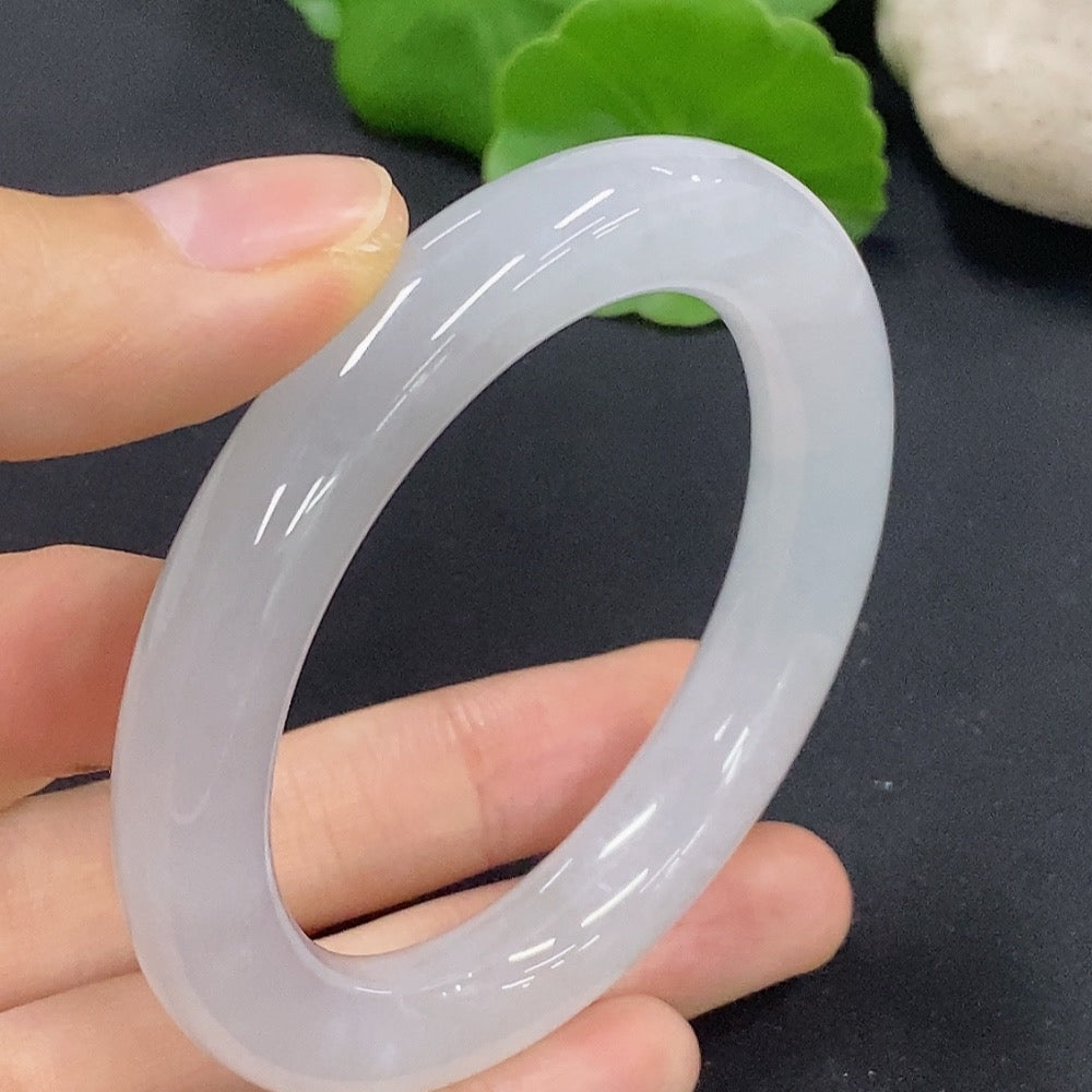 Jadeite round bangle with size 50.2 and weight 50.18g, crafted from smooth green jade, displayed on a neutral background.