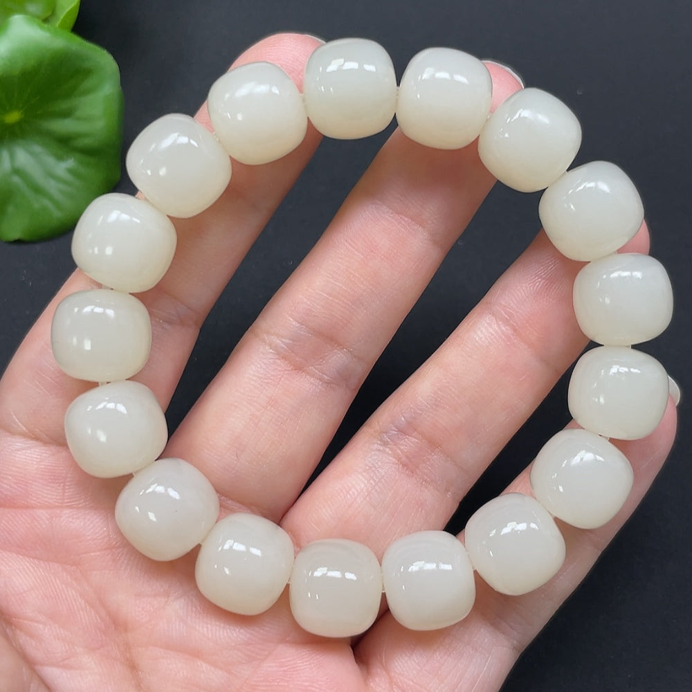 HKHQ Hetian Jade bracelet with 12mm beads, approximately 49.78g, showcasing smooth, polished green jade stones.