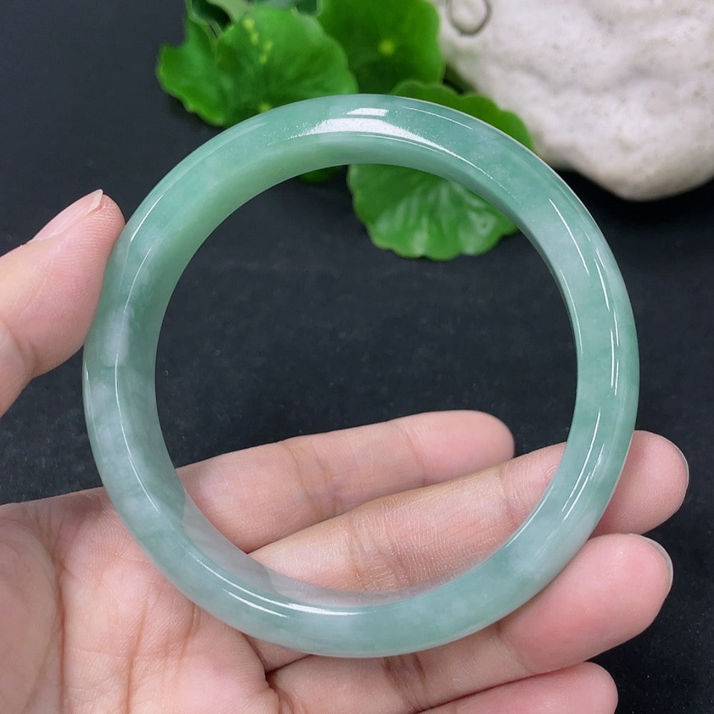 Jadeite round bangle from HKHQ, 56.8mm size, smooth polished surface, approximately 50.5g weight, showcasing vibrant green jade.
