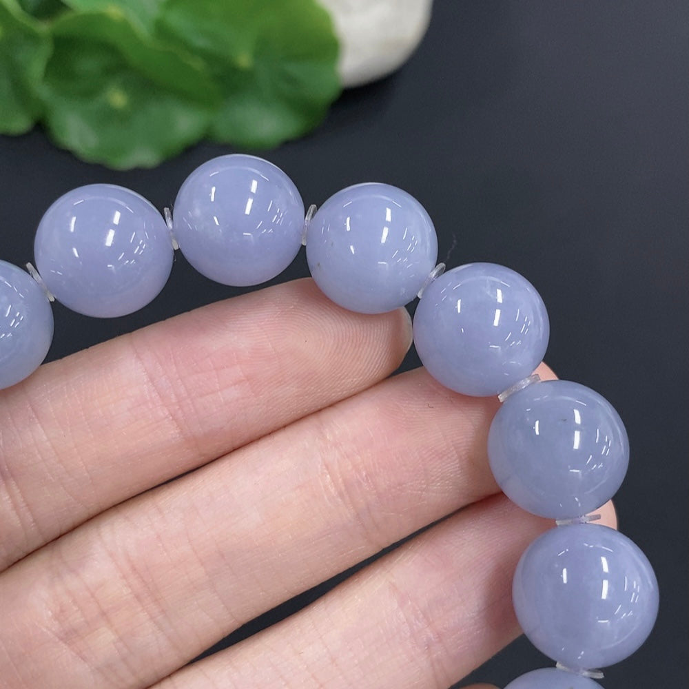 HKHQ jadeite bracelet weighing 56.7g with 12.7mm stones, showcasing smooth, polished green jade beads on a jewelry image.