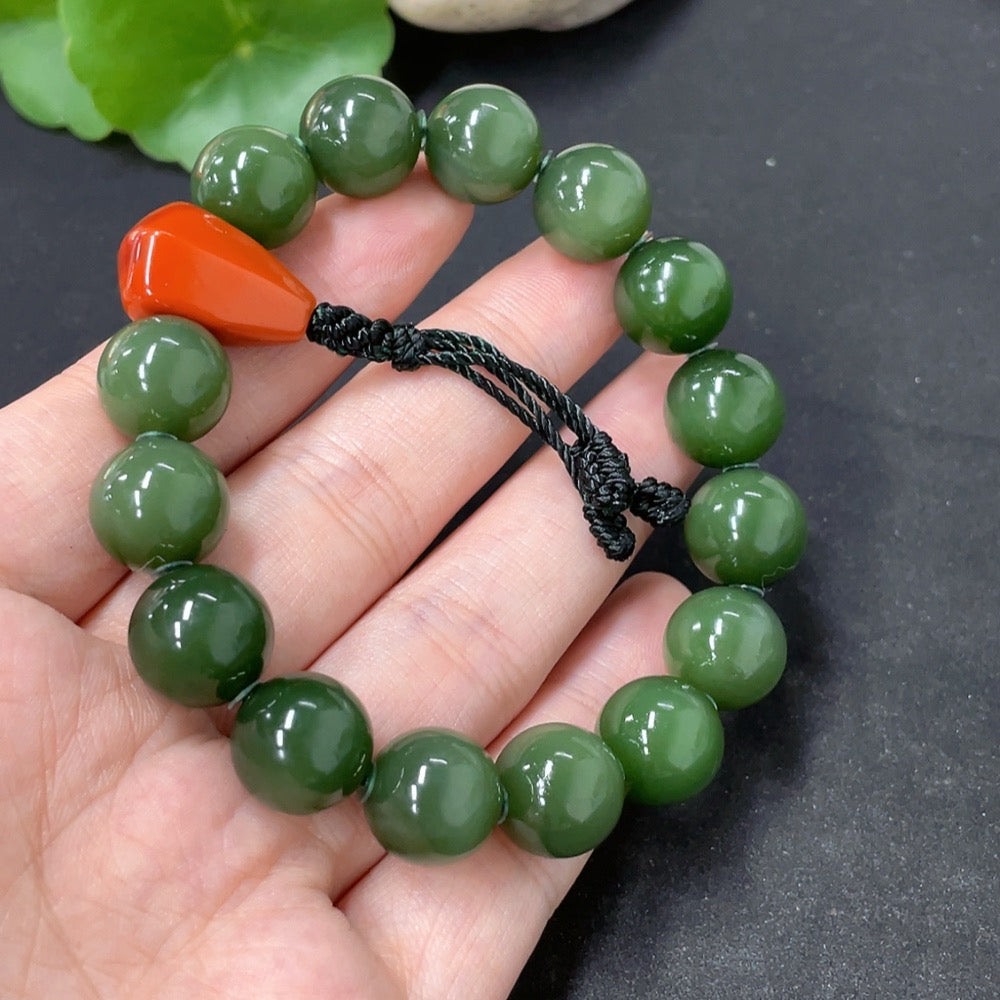HKHQ Hetian Jade bracelet with 11.5mm beads, organic southern red accents, weighing about 43.6g, showcasing smooth, polished jade beads.