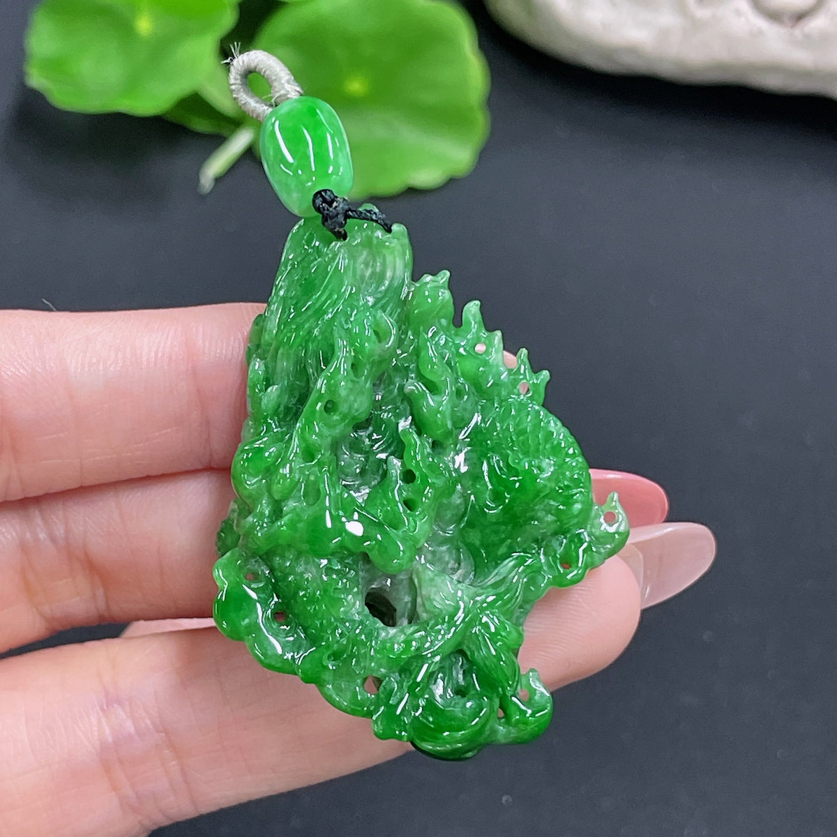 Jadeite dragon pendant with intricate carving, weight approximately 23.97g, crafted by HKHQ, featuring a detailed dragon design.